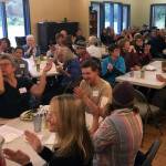 Former members of the False Island Young Adult Conservation Corps applaud John Harmony, former project manager of the camp, during the groups reunion Friday, July 19, 2019, at the Eagle River United Methodist Camp in Juneau. (Michael S. Lockett | Juneau Empire)