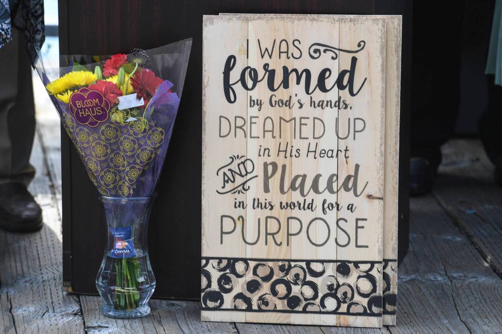 Flowers for Ashley DeRamus and gift signs to be given away during a ceremony at the U.S.S. Juneau Memorial on the Seawalk on Monday, July 22, 2019. DeRamus, who has Down syndrome, has recited the Pledge of Allegiance and sung the Nation Anthem in all 50 states with Alaska being her 50th on Monday. DeRamus, through her Ashley DeRamus Foundation, works to increase awareness of Down syndrome and enlighten others about the rewards and positive contributions those with Down syndrome make to society. (Michael Penn | Juneau Empire)