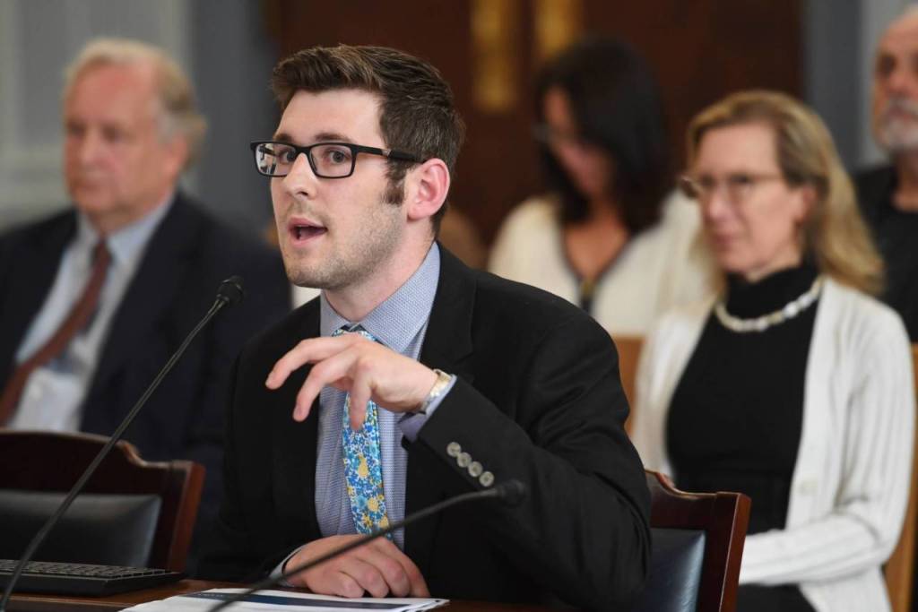 how the office performs sweeps of unspent money in various government accounts during a Senate Finance meeting at the Capitol on Thursday, July 18, 2019. Donna Arduin, Director of the Office of Management and Budget, right, watches in the background. (Michael Penn | Juneau Empire)