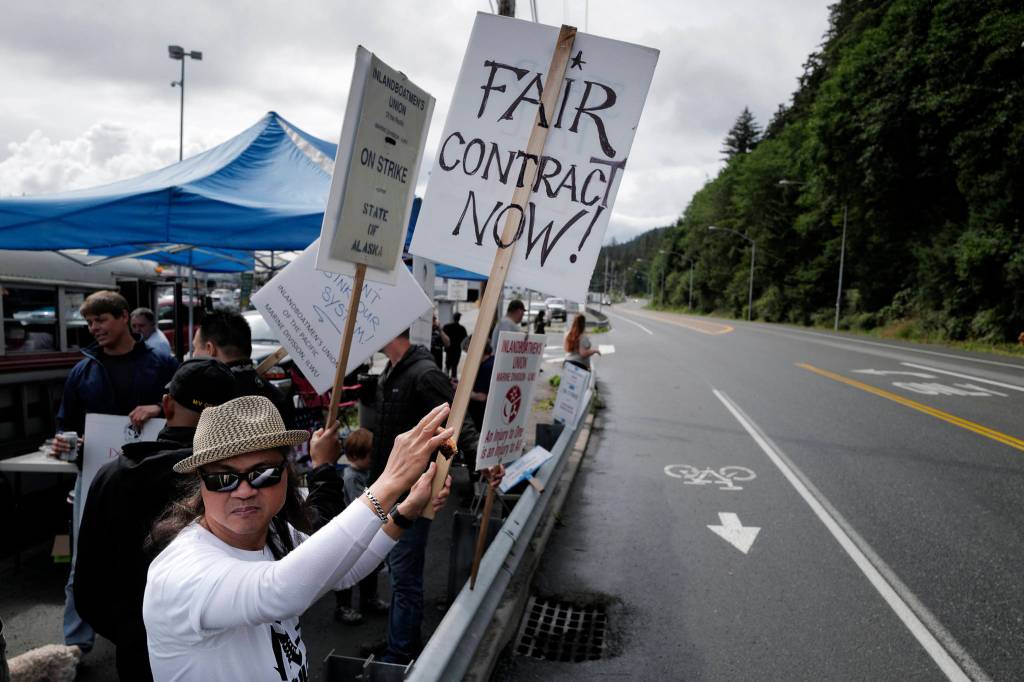 Roland Lumbab mans the picket line with others on the third day of the Inland Boatmens Union of the Pacifics strike against the Alaska Marine Highway System at the Auke Bay Terminal on Friday, July 26, 2019. (Michael Penn | Juneau Empire)