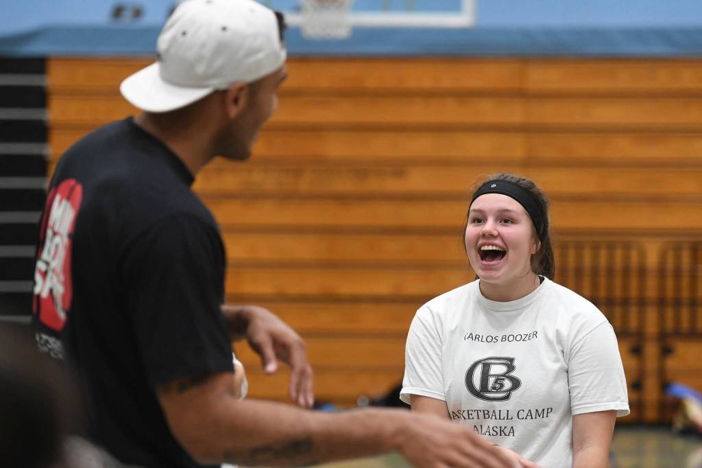 Student Kaia Smith, 15, practices her Haida language with former professional basketball player Damen Bell-Holter during the Latseen Hoop Camp at Dzantaki Heeni Middle School on Monday, July 29, 2019. The camp runs all week for students entering grades 6-12. (Michael Penn | Juneau Empire)