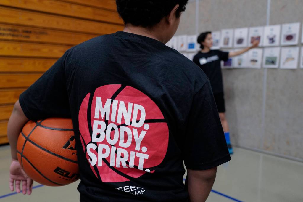 A student listens to Rico Worl teach them the Tlingit language during the Latseen Hoop Camp at Dzantaki Heeni Middle School on Monday, July 29, 2019. The camp runs all week for students entering grades 6-12. (Michael Penn | Juneau Empire)