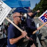 John Vercessi, left, and Dave Bell man the picket line for the Inlandboatmens Union of the Pacific at the Alaska Marine Highway Systems Auke Bay Terminal on Tuesday, July 30, 2019. Vercessi works as a seaman on the MV LeConte and Bell is a relief boatswain. (Michael Penn | Juneau Empire)