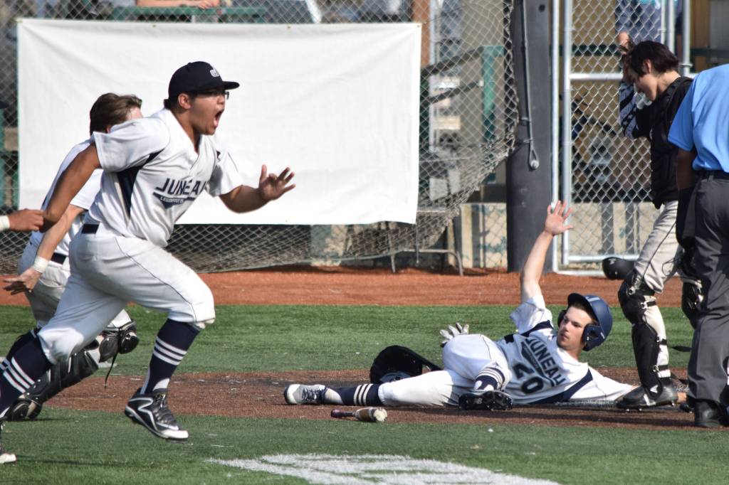 Juneau Post 25s Kona Ogoy, left, and Donavin McCurley celebrate Bobby Coxs walk-off single in the bottom of the eighth inning against South Post 4 in the American Legion state semifinals at Mulcahy Stadium in Anchorage on Tuesday, July 30, 2019. Juneau won 5-4. (Nolin Ainsworth | Juneau Empire)