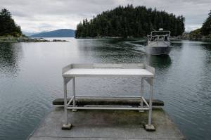A fisherman approaches the boat launch with its current fish cleaning station at Amalga Harbor on Wednesday, June 19, 2019. (Michael Penn | Juneau Empire)