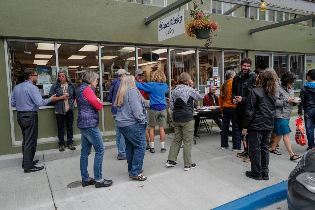 Juneau residents line up outside of the Planet Alaska Gallery to sign an application petition to recall Gov. Mike Dunleavy on Thursday, Aug. 1, 2019. (Michael Penn | Juneau Empire)