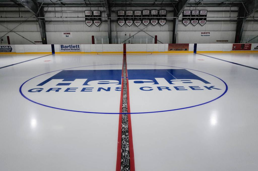 The red line at the Treadwell Arena on Thursday, August 1, 2019. Tsimshian artist Abel Ryan Tsimshian worked with students in the BAM After School Program to draw animals in Northwest Coast formline designs to be incorporated in the hockey rink ice. The Treadwell Arena opens for the season on Monday. (Michael Penn | Juneau Empire)