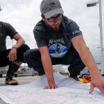 Liam Godfrey-Jolicoeur, left, and Jake Dombek, talk at Harris Harbor on Thursday, Aug. 2, 2019, about their nearly two-month long trip up the Inside Passage by canoe. Both are orginally from Vermont used the trip to raise money and bring awareness to environmental causes. (Michael Penn | Juneau Empire)