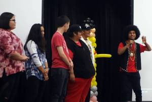 Members of Ix̱six̱án, Ax̱ Ḵwáan Jaylynn Martin, Jordan Bennett, Keegan Kanan, Arturo Rodriguez and Colin Rose watch Arias Hoyle explain the meaning behind the song and music video Spirit Saturday, Aug. 3, 2019. (Ben Hohenstatt | Capital City Weekly)