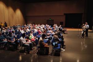 Juneau residents listen to Rep. Andi Story, D-Juneau, Sen. Jesse Kiehl, D-Juneau, and Rep. Sara Hannan, speak during a town hall meeting at Centennial Hall on Thursday, Aug. 8, 2019. (Michael Penn | Juneau Empire)