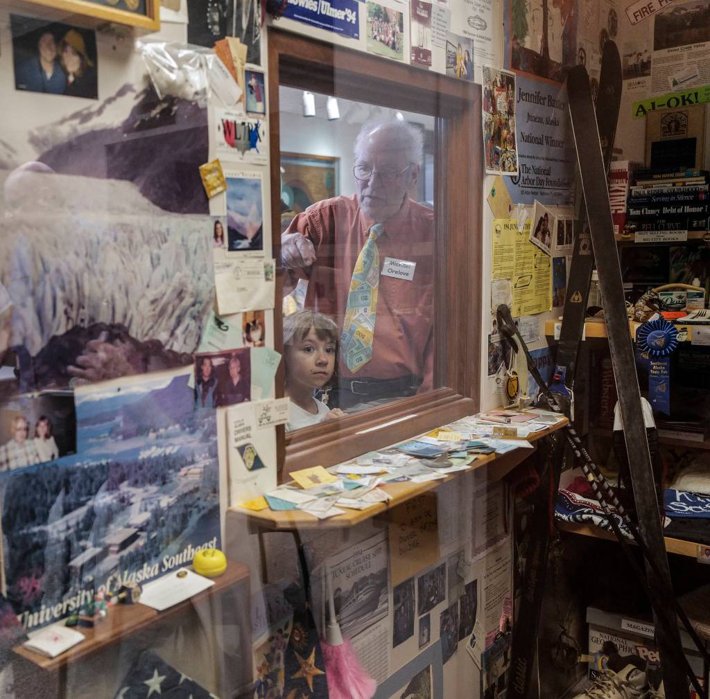 Michael Orelove points out items to his Grandniece, Violet, inside the 1994 Juneau Time Capsule at the Hurff Ackerman Saunders Federal Building in Juneau on Friday, Aug. 9, 2019. Twenty-five year ago a janitors closet was turned into the Juneau Time Capsule. The capsule is set to be opened in 75 more years. (Michael Penn | Juneau Empire)