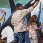 Wyland, a Laguna Beach-based artist, paints a mural with Southeast Alaska children at Icy Strait Point, Saturday, Aug. 10. The visiting artist took inspiration from orcas he saw near Hoonah. (Courtesy Photo | Icy Strait Point)