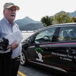 Mike Orford stands next to his brand new 2019 Chevy Bolt Electric Vehicle on Monday, Aug. 12, 2019. Orford, who has been a taxi driver for EverGreen Taxi, plans to put into zero emission vehicle into service to reduce costs and lead the way for a more sustainable way of life. (MIchael Penn | Juneau Empire)