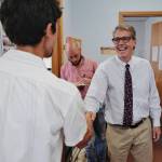 Juneau City Manager Rorie Watt, right, greets Greg Smith after Smith applied to run for one of two Assembly District 1 seats in this falls municipal election on Monday, Aug. 12, 2019. Watt said, Welcome to the fray. (Michael Penn | Juneau Empire)