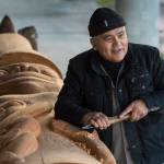 Wayne Price, master Tlingit carver and Associate Professor of Northwest Coast Arts and Sciences, works on a healing pole at the University of Alaska Southeast on Wednesday, Oct. 31, 2018. (Michael Penn | Juneau Empire File)