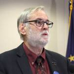 University of Alaska Board of Regents chairman John Davies speaks at a news conference in Anchorage, Alaska, Tuesday, Aug. 13, 2019, where Gov. Mike Dunleavy announced he would support a $25 million cut this year to the University of Alaska system. That is a sharp reversal from the $135 million cut Dunleavy earlier endorsed. (AP Photo/Mark Thiessen)