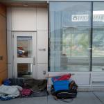 A homeless person sleeps in the doorway at the Capital Transit Center on Tuesday, Aug. 13, 2019. The Glory Hall, Juneaus emergency shelter and soup kitchen, is closing their doors from 7 a.m. to 2 p.m. daily due to budget cuts forcing their homeless clients to find other places to be. Oatmeal and coffee were available to clients before leaving the shelter but no lunch is available. (Michael Penn | Juneau Empire)