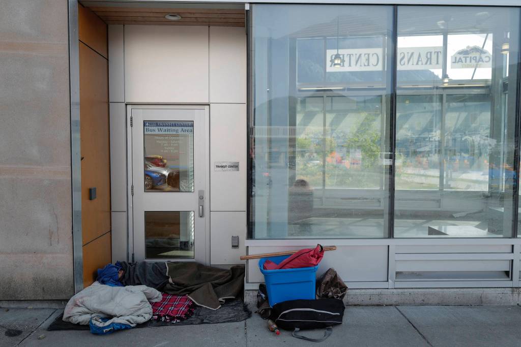 A homeless person sleeps in the doorway at the Capital Transit Center on Tuesday, Aug. 13, 2019. (Michael Penn | Juneau Empire)