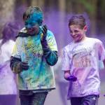 Runners get hit with purple dye during Raining Colors 5K Fun Run in 2016. (Michael Penn | Juneau Empire File)
