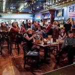An audience watches a painting performance during the GRLZ open mic night at the The Rendezvous Bar on Wednesday, Aug. 14, 2019. (Michael Penn | Juneau Empire)