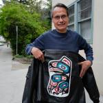 Henry James shows off his leather jacket painted by his uncle, Ivan James, on Friday, Aug. 16, 2019. Ivan James, an Alaska Native artist, was found dead on Aug. 3 at Cope Park. He was a veteran and the artist behind murals still visible at the Juneau Arts & Culture Center. (Michael Penn | Juneau Empire)