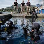 Sgt. Cesar Rodriquez, left, and Sgt. Kenneth Byrd, of the U.S. Armys 74th Engineer Dive Detachment check their gauges one last time before submerging on a project at the Don D. Statter Boat Harbor in Auke Bay on Friday, Aug. 16, 2019. Members of the U.S. Armys 74th Engineer Dive Detachment and U.S. Coast Guard Regional Dive Locker West worked together to inspect and replace the bolts holding the harbors breakwater together. (Michael Penn | Juneau Empire)