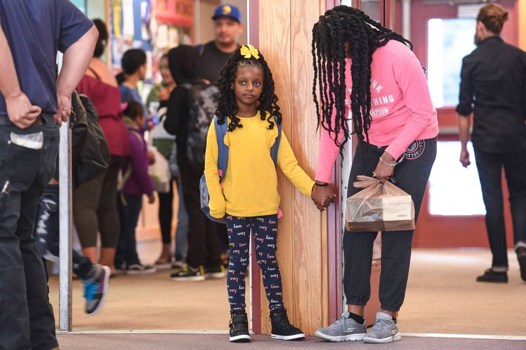 Ariyah Allen, holds hands with her mother, Odette, after arriving for the first day of school at Riverbend Elementary School on Monday, Aug. 19, 2019. (Michael Penn | Juneau Empire)