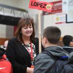 Sixth grade Social Studies Teacher Janet Lopez introduces herself to students arriving for the first day of school at Floyd Dryden Middle School on Monday, Aug. 19, 2019. (Michael Penn | Juneau Empire)