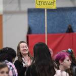 Sixth grade Language Arts Teacher Rachelle Grossardt waves to students arriving for the first day of school at Floyd Dryden Middle School on Monday, Aug. 19, 2019. (Michael Penn | Juneau Empire)