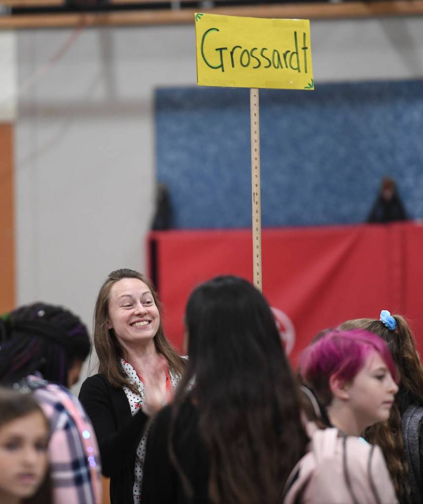 Sixth grade Language Arts Teacher Rachelle Grossardt waves to students arriving for the first day of school at Floyd Dryden Middle School on Monday, Aug. 19, 2019. (Michael Penn | Juneau Empire)