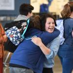 Freshman Jetta Hosiner, right, and Freshman Taren Wright hug as Freshman Kelsi Sell, left, looks on after arriving for the first day of school at Thunder Mountain High School on Monday, Aug. 19, 2019. (Michael Penn | Juneau Empire)