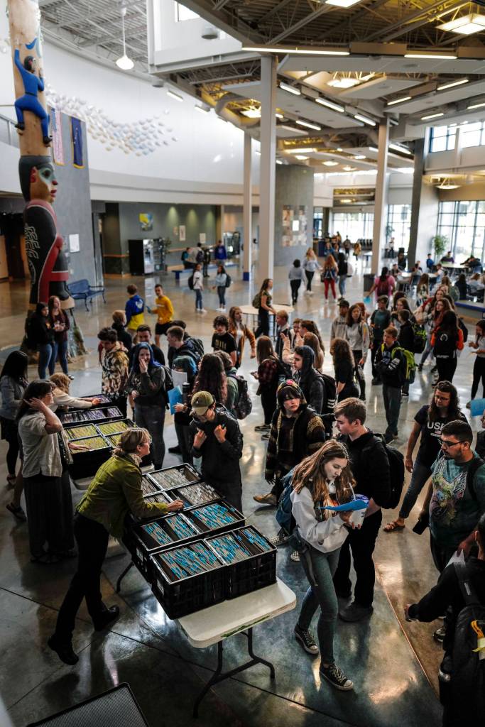 Students pick up their schedules after arriving for the first day of school at Thunder Mountain High School on Monday, Aug. 19, 2019. (Michael Penn | Juneau Empire)