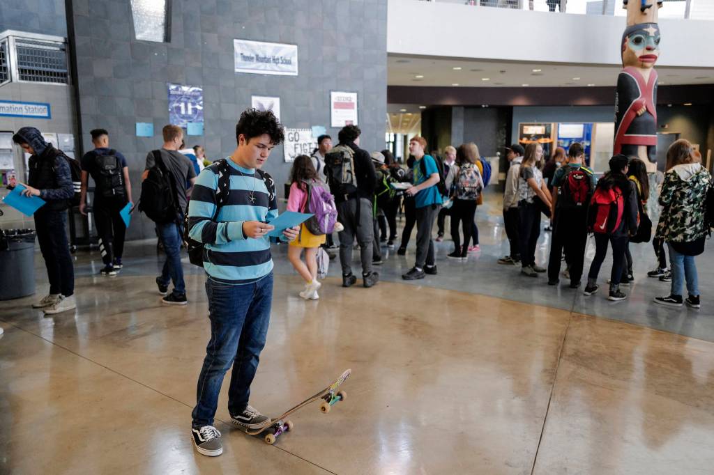 Junior James Hodges studies his schedule after arriving for the first day of school at Thunder Mountain High School on Monday, Aug. 19, 2019. (Michael Penn | Juneau Empire)