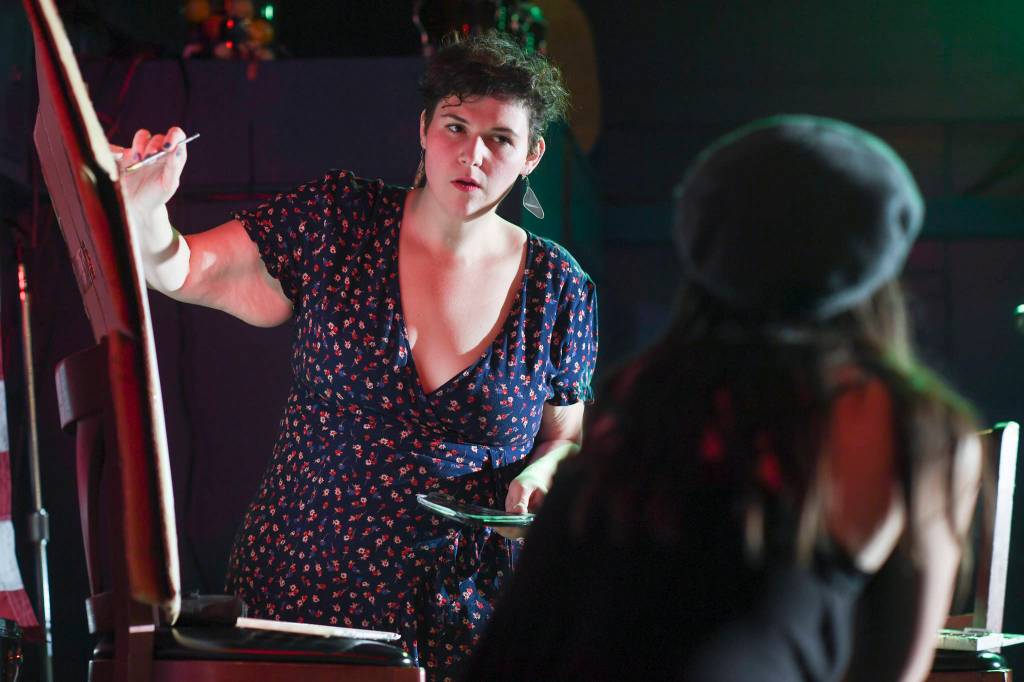Natalie Weinberg performs with a live model painting of Dana Herndon and Serena Drazkowski during the GRLZ open mic night at the The Rendezvous Bar on Wednesday, Aug. 14, 2019. (Michael Penn | Juneau Empire)