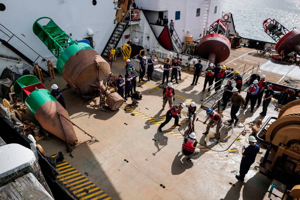Members of the U.S. Coast Guard, U.S.C.G Dive Team, U.S. Army Dive Team and the Canadian Coast Guard participate in the annual Buoy Tender Olympics at Station Juneau on Wednesday, Aug. 21, 2019. (Michael Penn | Juneau Empire)