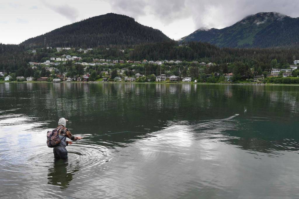 Zack Zetter fishes for Dolly Varden downtown on Tuesday, June 4, 2019. (Michael Penn | Juneau Empire)