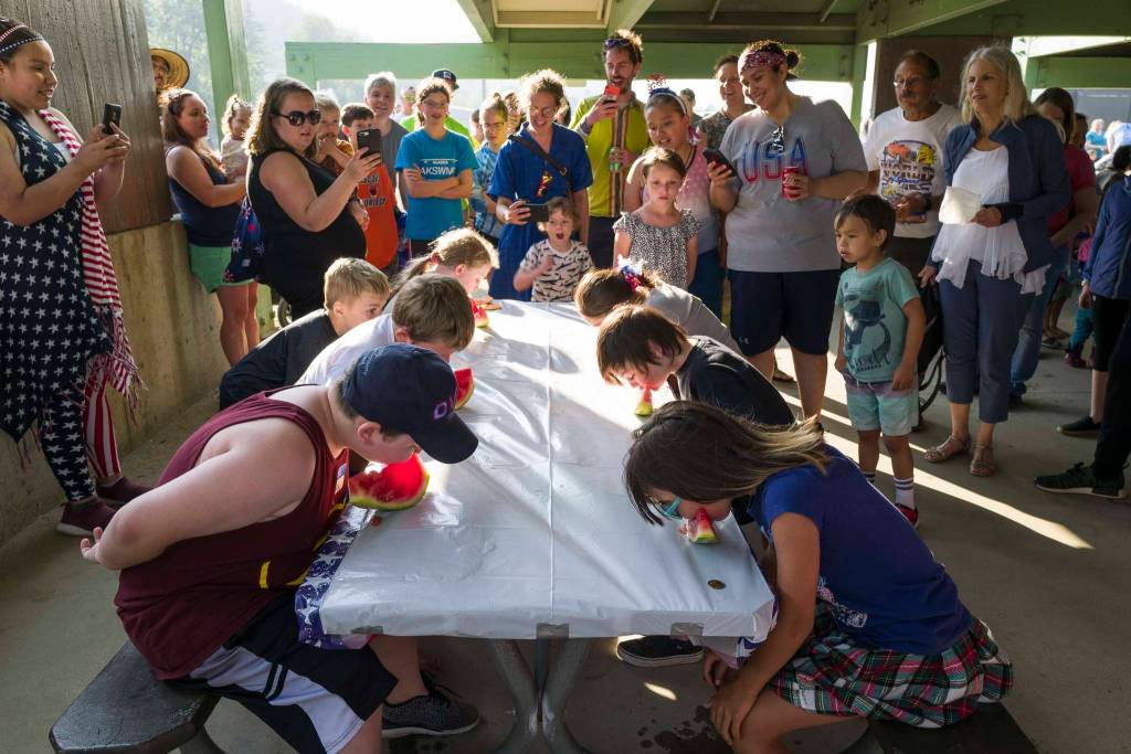 Children participate in a watermelon eating contest during a community picnic sponsored by the Douglas Fourth of July Committee and Capital City Fire/Rescue at Sandy Beach on Wednesday, July 3, 2019. (Michael Penn | Juneau Empire)