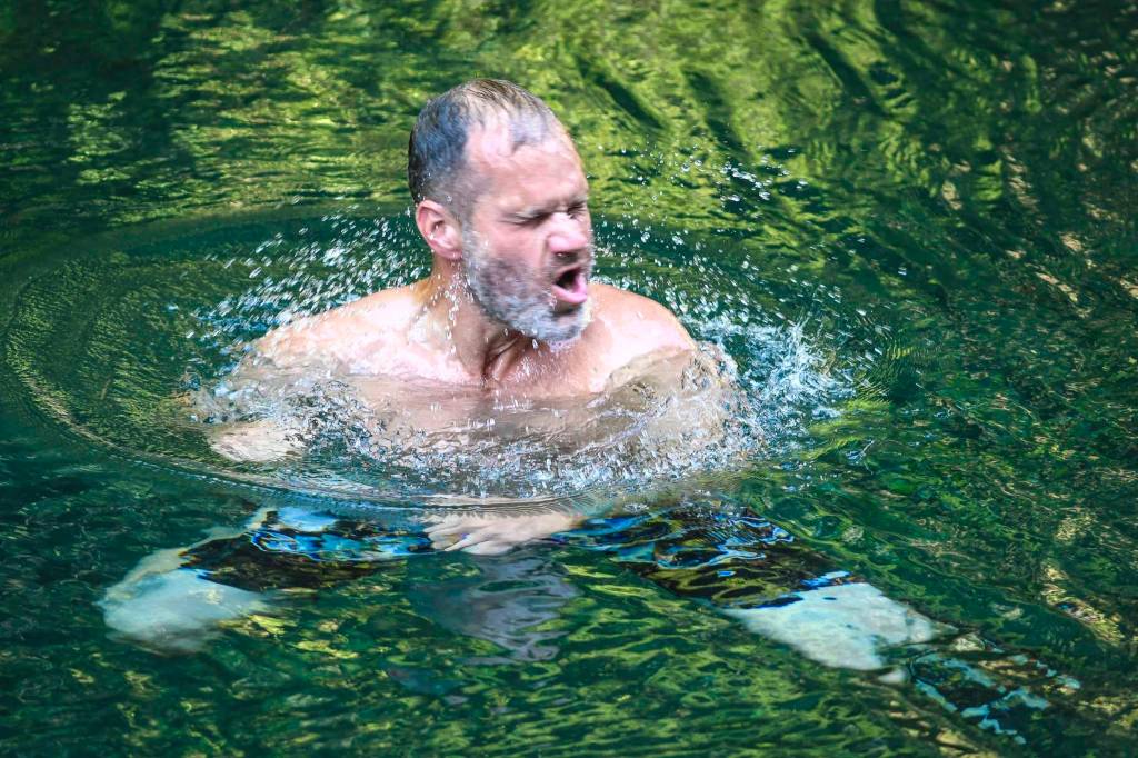 Iver Nore shakes the water off his face as he takes a swim in Gold Creek on Friday, Aug. 2019. Temperatures are expected to hit their highs in the 70s through Monday. (Michael Penn | Juneau Empire)