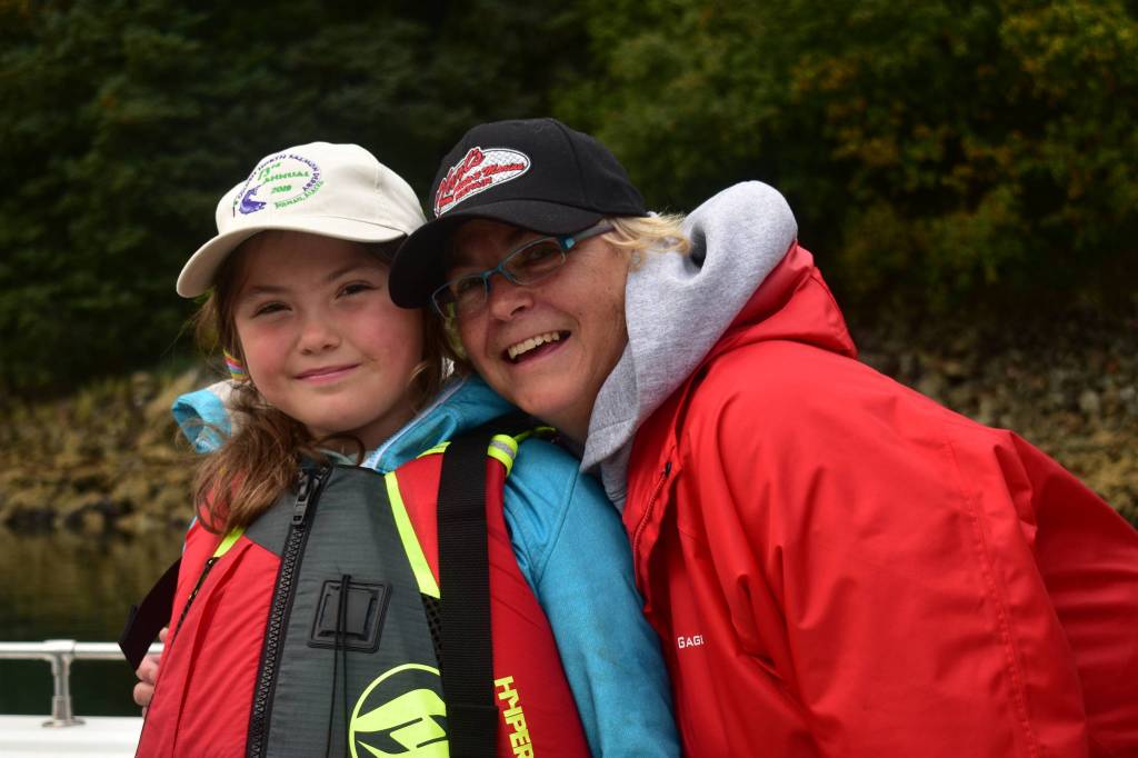 Elise Kanouse, 7, and her grandmother Ellie Fitzjerrald drop off fish at the Mike Pusich Harbor in Douglas on Sunday, Aug. 25, 2019. (Peter Segall | Juneau Empire)