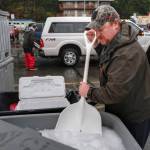 Scott Sell shovels ice at the Don D. Statter Boat Harbor in Auke Bay before the start of the Golden North Salmon Derby on Friday, Aug. 23, 2019. (Michael Penn | Juneau Empire)