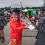 Cheri Wharton validates Jeremy Dunns tickets at the Don D. Statter Boat Harbor in Auke Bay at the start of the Golden North Salmon Derby on Friday, Aug. 23, 2019. (Michael Penn | Juneau Empire)