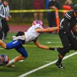 Juneaus Ali Beya breaks tackles by Antelope Unions Sam Martinez, left, and Chris Pelfry to score in the first quarter at Adair-Kennedy Memorial Field on Saturday, Aug. 24, 2019. (Michael Penn | Juneau Empire)