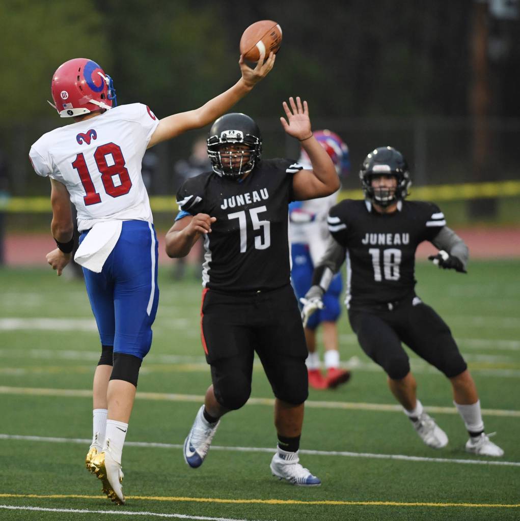 Juneaus Sam Sika, center, and Cooper Kriegmont pressure Antelope Unions quarterback Trey Hohlbein in the second quarter at Adair-Kennedy Memorial Field on Saturday, Aug. 24, 2019. (Michael Penn | Juneau Empire)