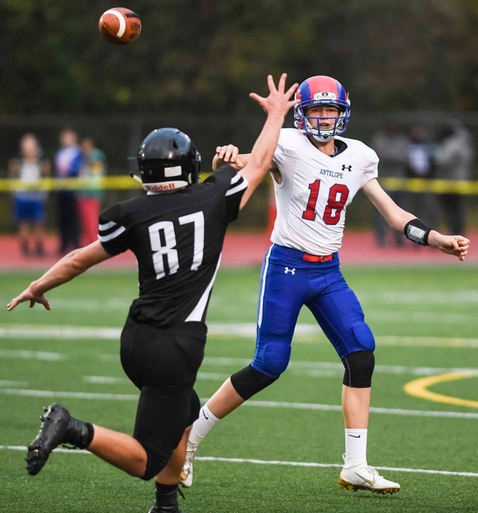 Juneaus Cole Jensen, left, pressures Antelope Unions quarterback Trey Hohlbein at Adair-Kennedy Memorial Field on Saturday, Aug. 24, 2019. Juneau won 56-18. (Michael Penn | Juneau Empire)