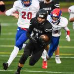 Juneaus Ali Beya, center, breaks away from Antelope Unions Jonathon Whitney, left, and Mickey Carrillo to score in the second quarter at Adair-Kennedy Memorial Field on Saturday, Aug. 24, 2019. Juneau won 56-18. (Michael Penn | Juneau Empire)