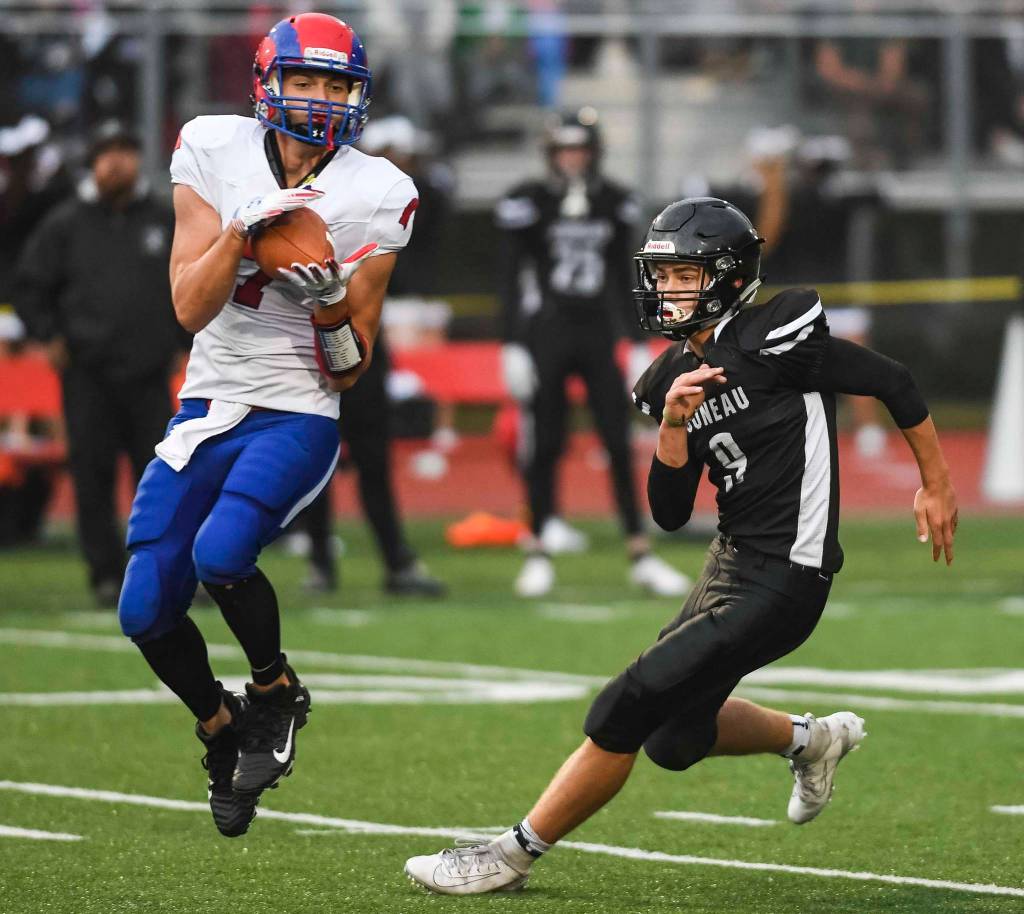 Antelope Unions Dylan Thomas, left, makes a catch in front of Juneaus Wallace Adams at Adair-Kennedy Memorial Field on Saturday, Aug. 24, 2019. Juneau won 56-18. (Michael Penn | Juneau Empire)