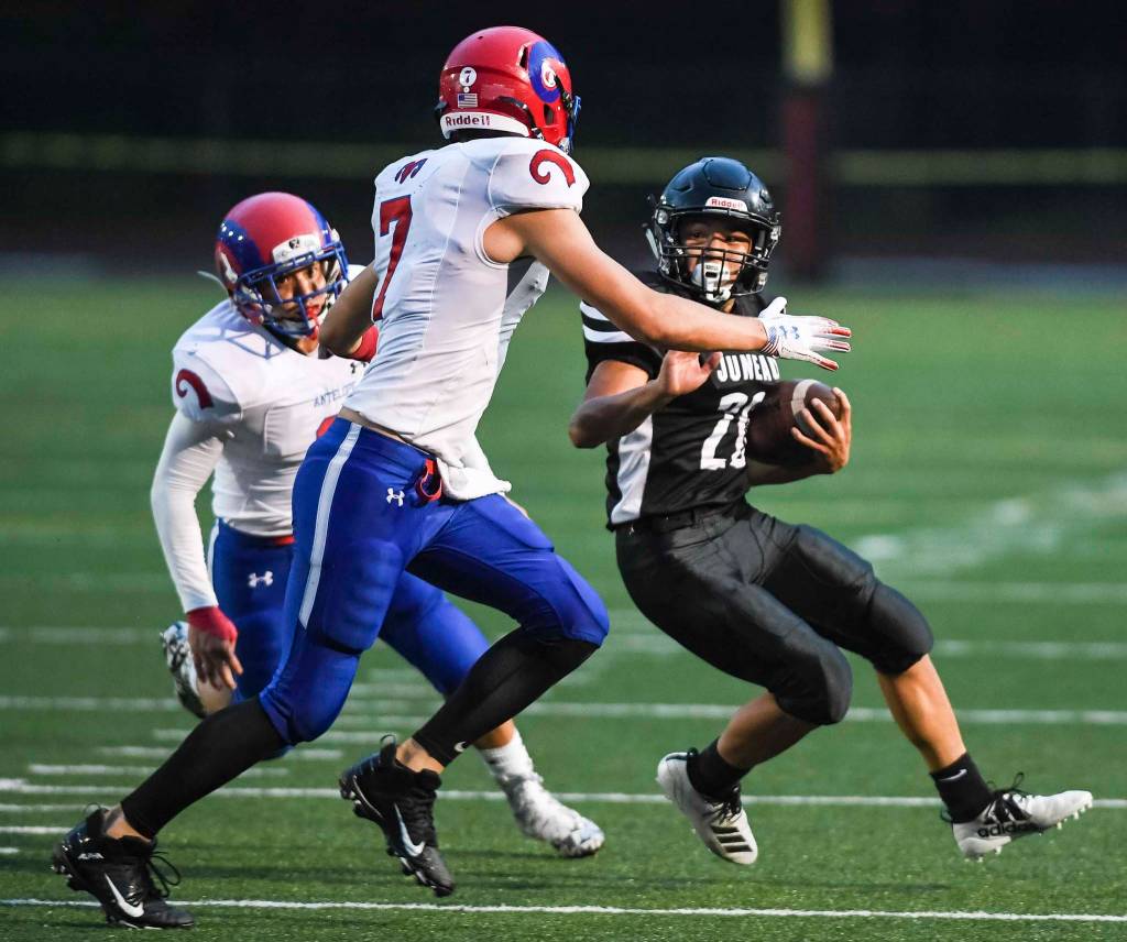 Juneaus Jamal Johnson, right, is rounded up by Antelope Unions Dylan Thomas, center, and Bruno Zazueta in the second quarter at Adair-Kennedy Memorial Field on Saturday, Aug. 24, 2019. Juneau won 56-18. (Michael Penn | Juneau Empire)