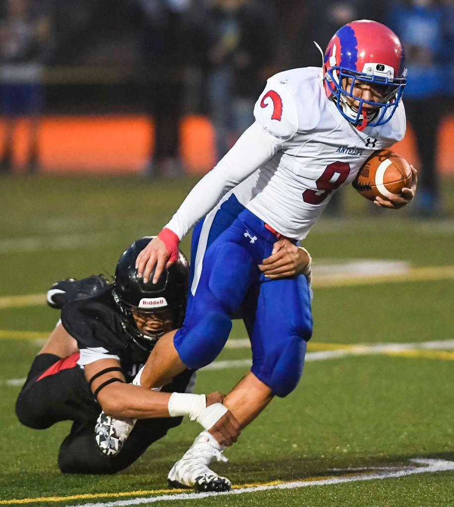 Juneaus Meki Toutaiolepo, left, tackles Antelope Unions Bruno Zazueta in the second quarter at Adair-Kennedy Memorial Field on Saturday, Aug. 24, 2019. Juneau won 56-18. (Michael Penn | Juneau Empire)