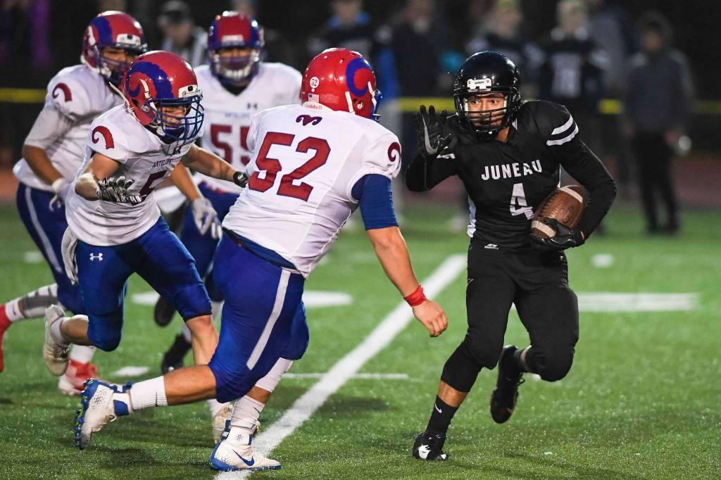 Juneaus Ali Beya is caught behind the line of scrimmage by Antelope Unions Alex Soto, center, and Chris Pelfry in the second quarter at Adair-Kennedy Memorial Field on Saturday, Aug. 24, 2019. Juneau won 56-18. (Michael Penn | Juneau Empire)