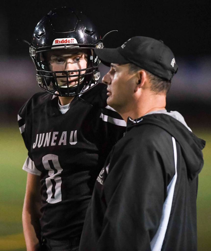 Juneaus Noah Chambers receives a play by coach Rich Sjoroos as they play against Antelope Union in the third quarter at Adair-Kennedy Memorial Field on Saturday, Aug. 24, 2019. Juneau won 56-18. (Michael Penn | Juneau Empire)